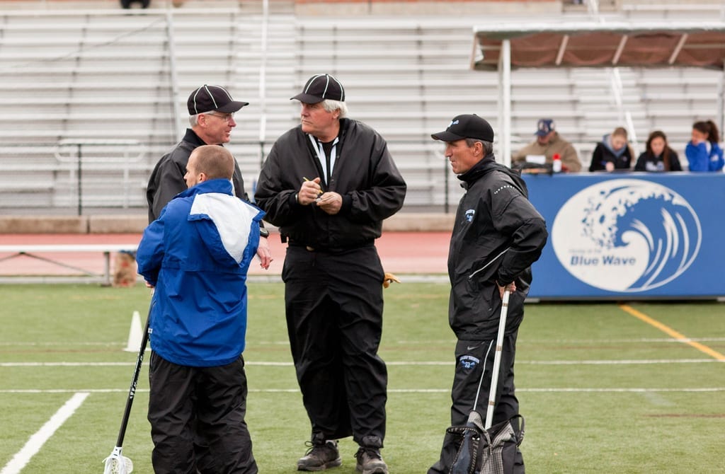 lacrosse officials referees pre game on field