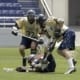 lacrosse two players battle for a loose ball