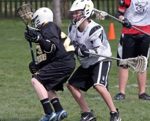 youth lacrosse body defense before stick checks
